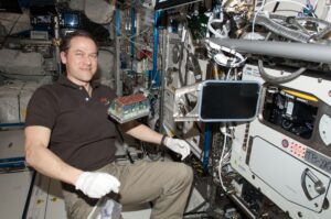 NASA astronaut Tom Marshburn with the Seedling Growth-1 seeds ready to load into the European Modular Cultivation System on the International Space Station.